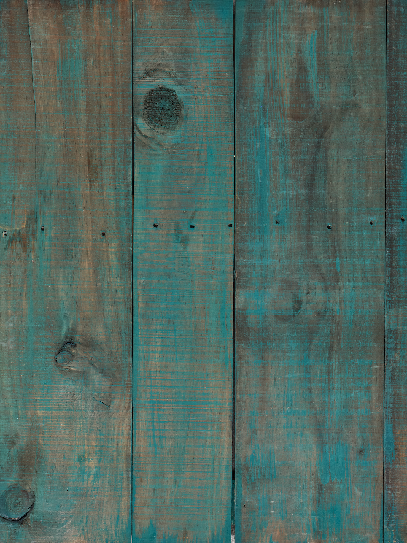 grey wood surface with faded blue paint