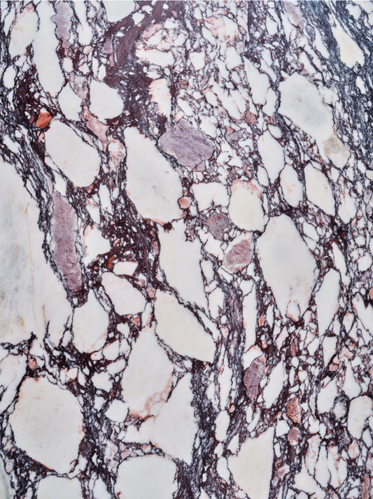Calacatta Viola vinyl backdrop. Vinyl image is of fragmented warm grays and whites with deep red streaks on marbled stone.