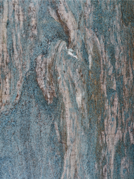 Caribe Quartzite vinyl background. Vinyl image is of light blue, deep blue, and a varied beige to brown marbled stone.