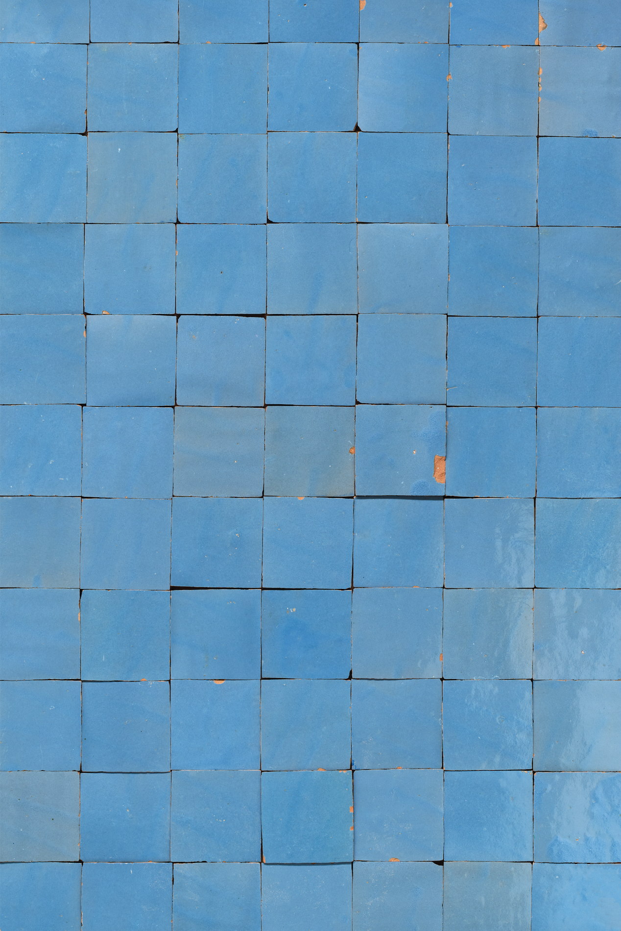 vinyl backdrop of blue square tiles with no grout surface